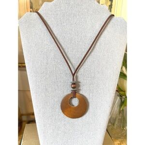 Brown wooden pendant necklace on a brown cord